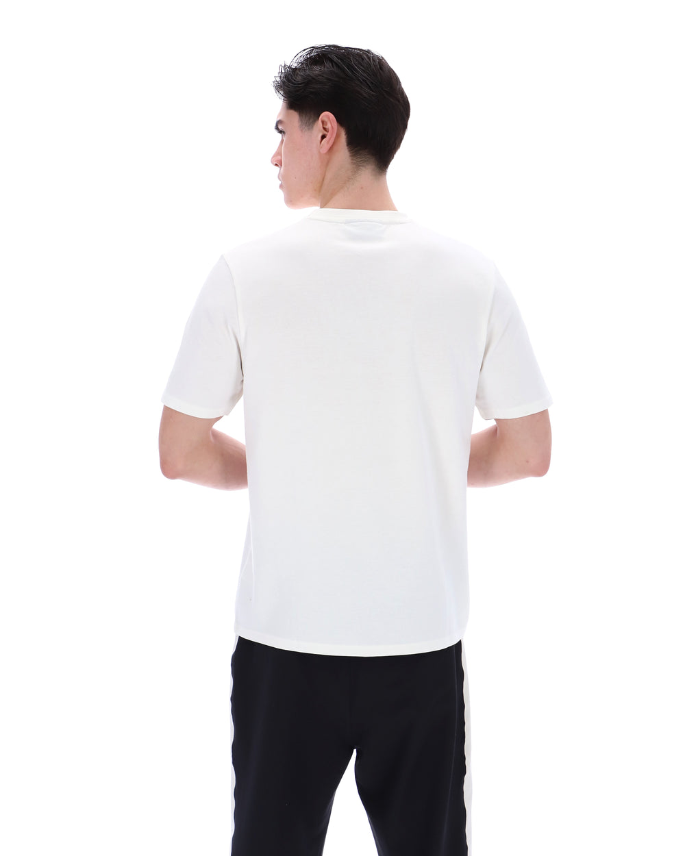 Person wearing a white polo shirt and black pants on a white background