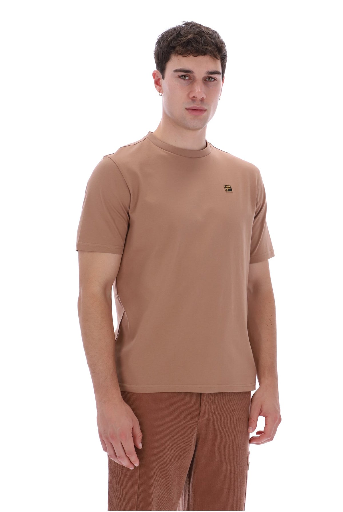 A man wearing a short-sleeve crew-neck t-shirt in a warm tan-brown color, paired with matching brown pants, photographed against a solid white background.