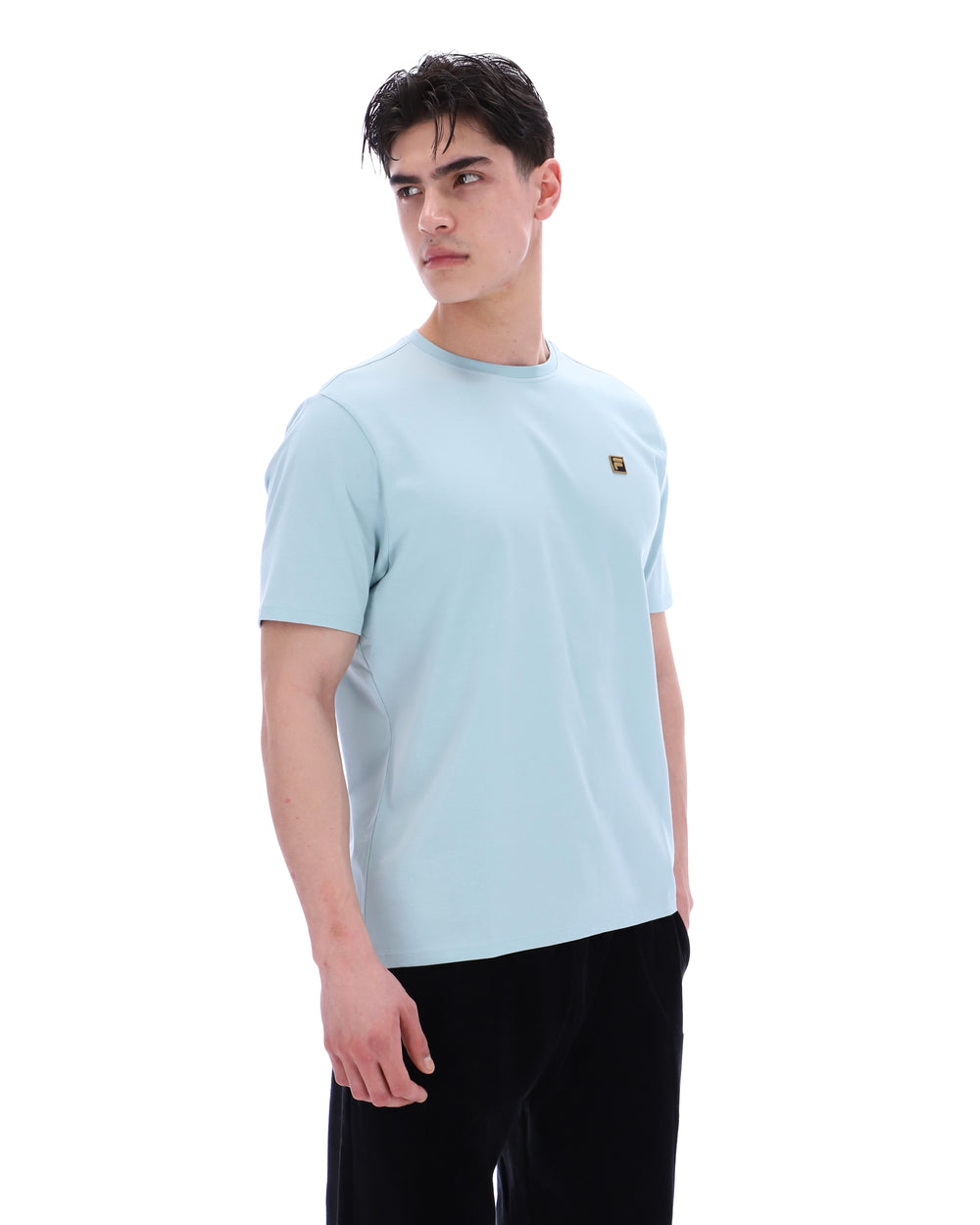 Man wearing a light blue t-shirt on a white background