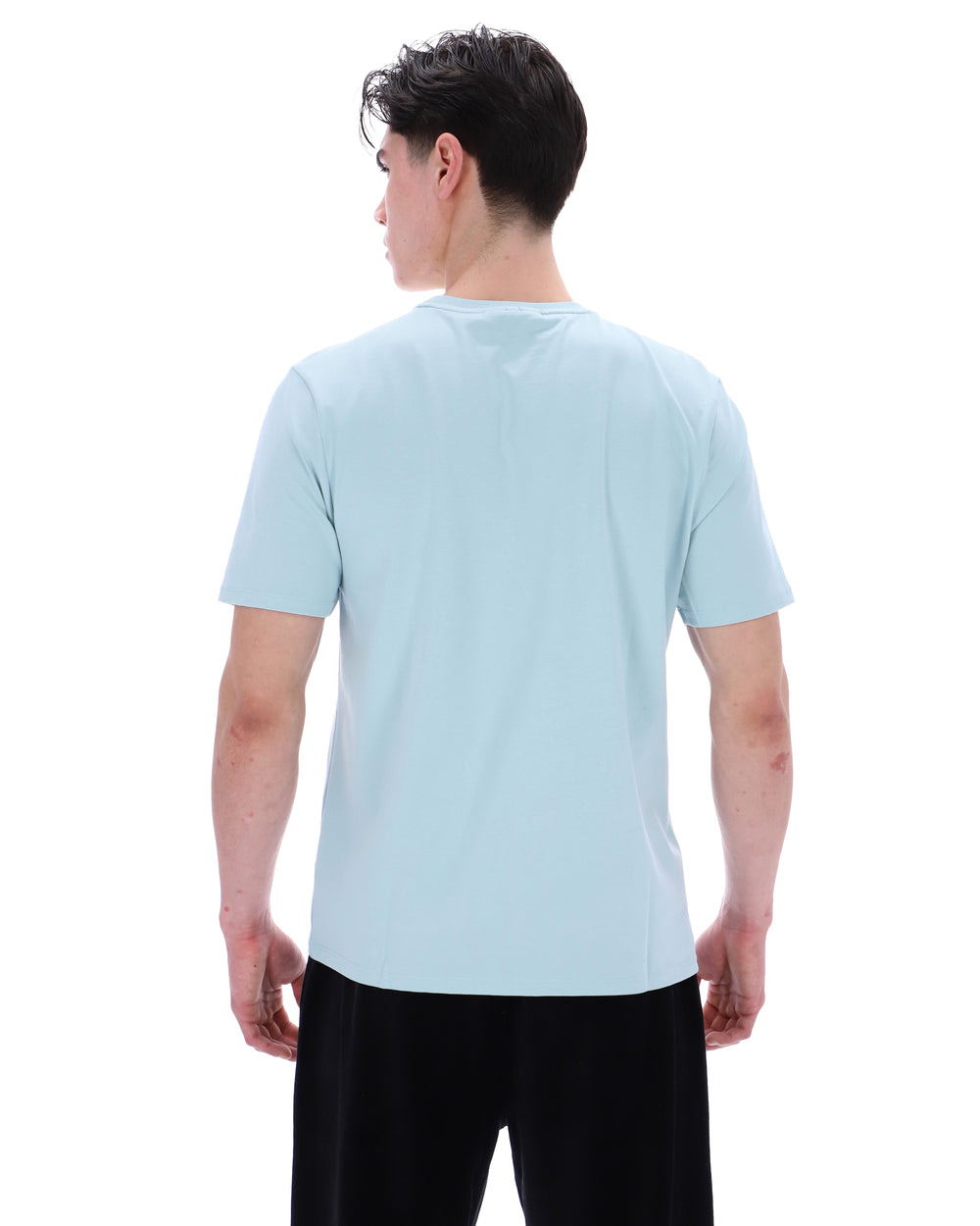 Person wearing a light blue t-shirt on a white background