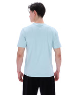 Person wearing a light blue t-shirt on a white background