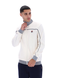 Displays a model wearing the Gardenia 'FILA' branded Zayn Track Top