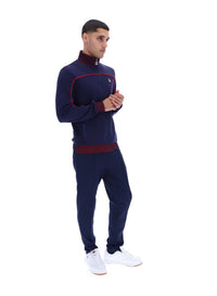 Displays a model wearing the Navy 'FILA' branded Zayn Track Top
