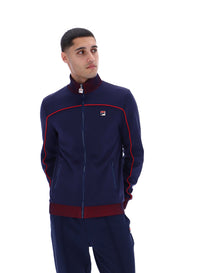Displays a model wearing the Navy 'FILA' branded Zayn Track Top