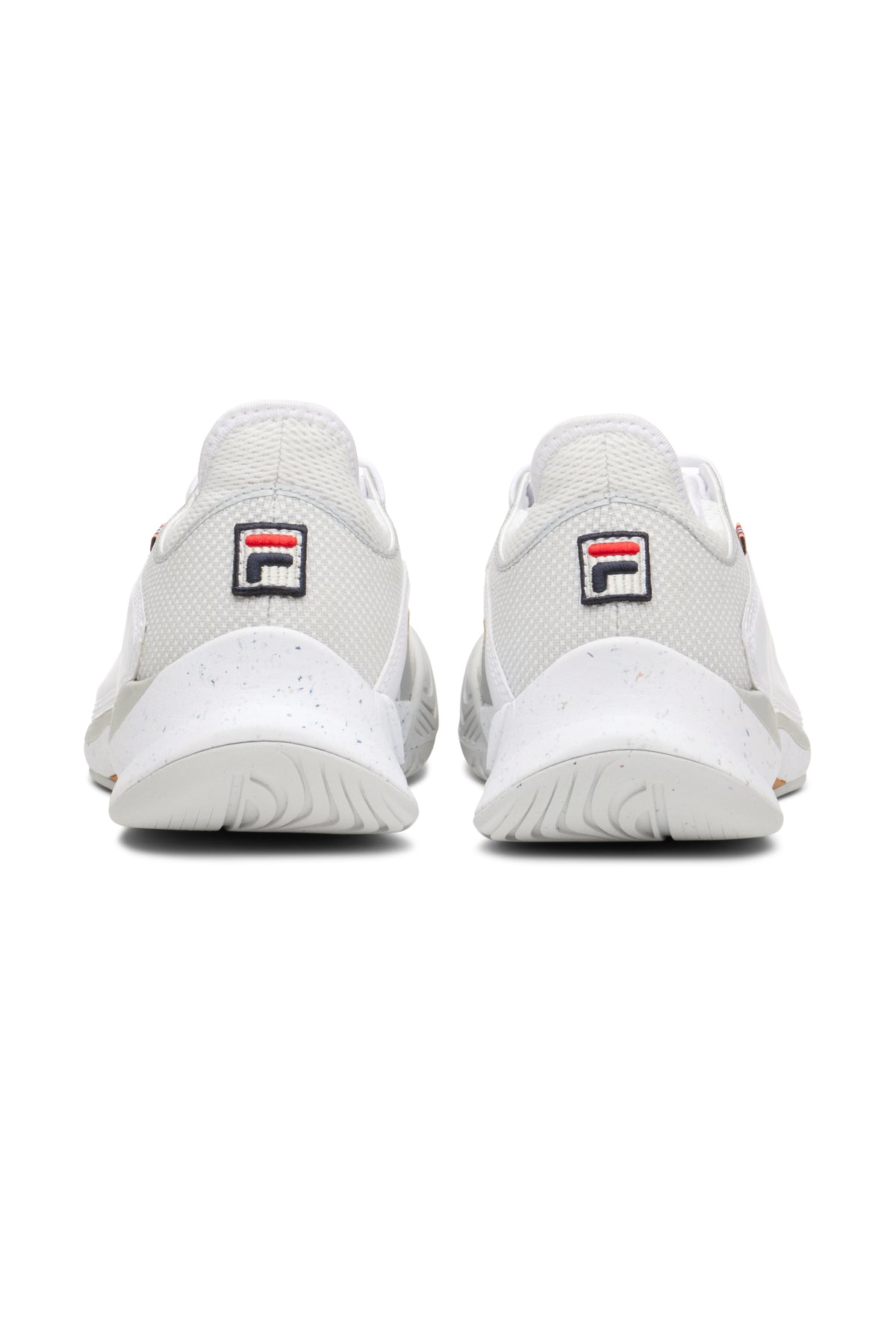 A pair of white FILA Mondo Forza tennis shoes with orange and grey accents on a white background.