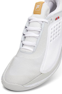 A pair of white FILA Mondo Forza tennis shoes with orange and grey accents on a white background.