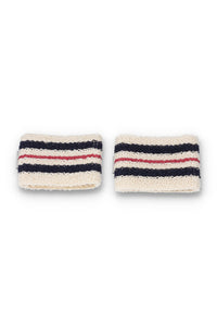 A pair of beige, red, and blue striped retro wristbands with the FILA logo.