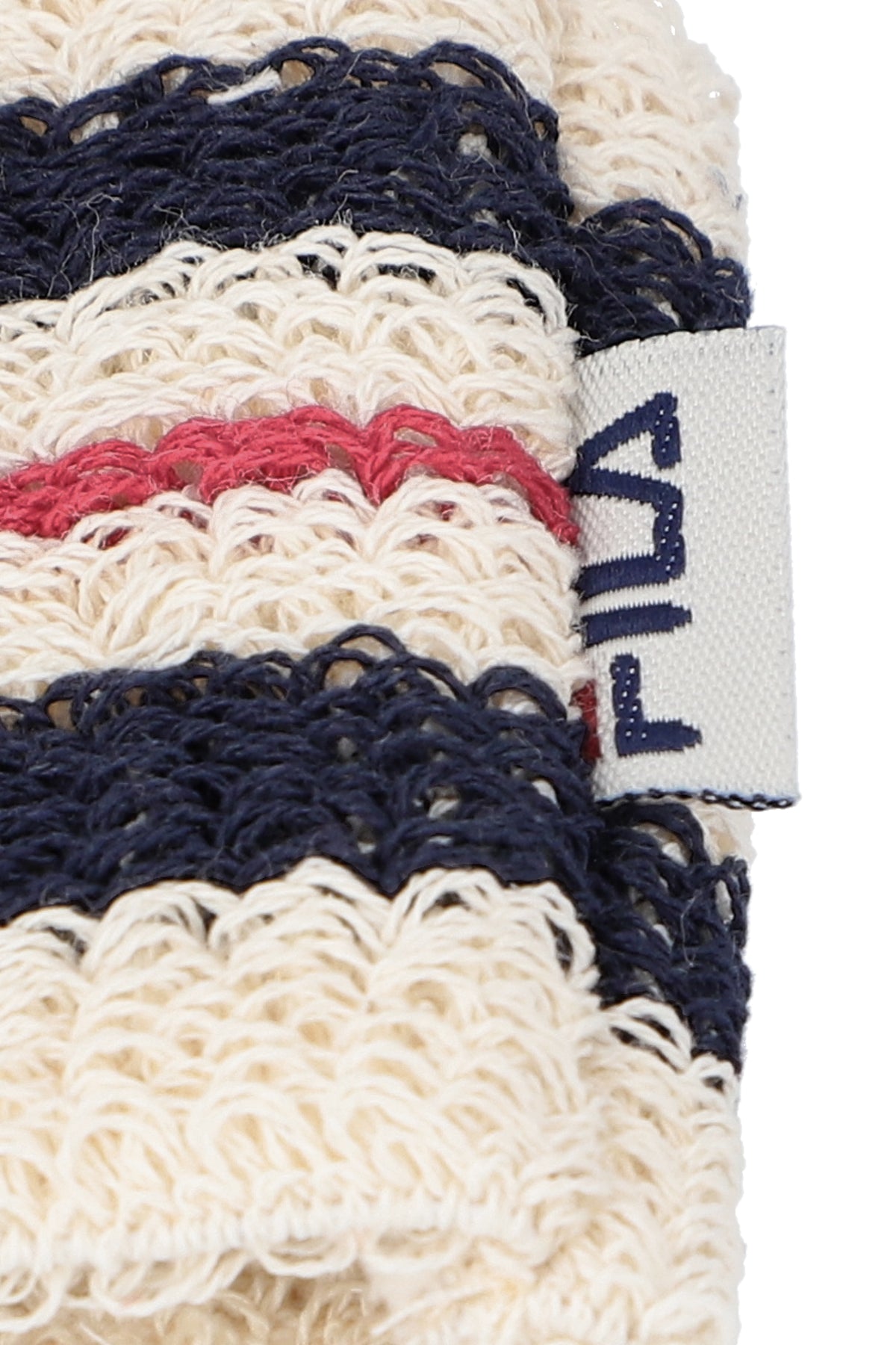 A close-up of a of beige, red, and blue striped retro wristbands with the FILA logo.