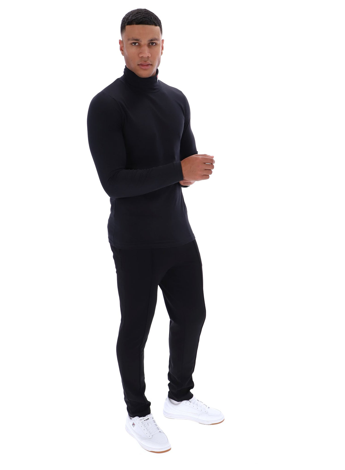 Man wearing a black turtleneck and pants set on a white background
