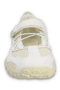 White sneaker with a light sole on a white background