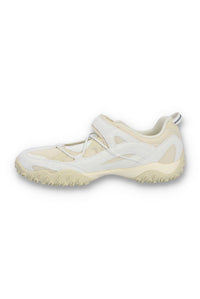 White and beige athletic shoe on a white background
