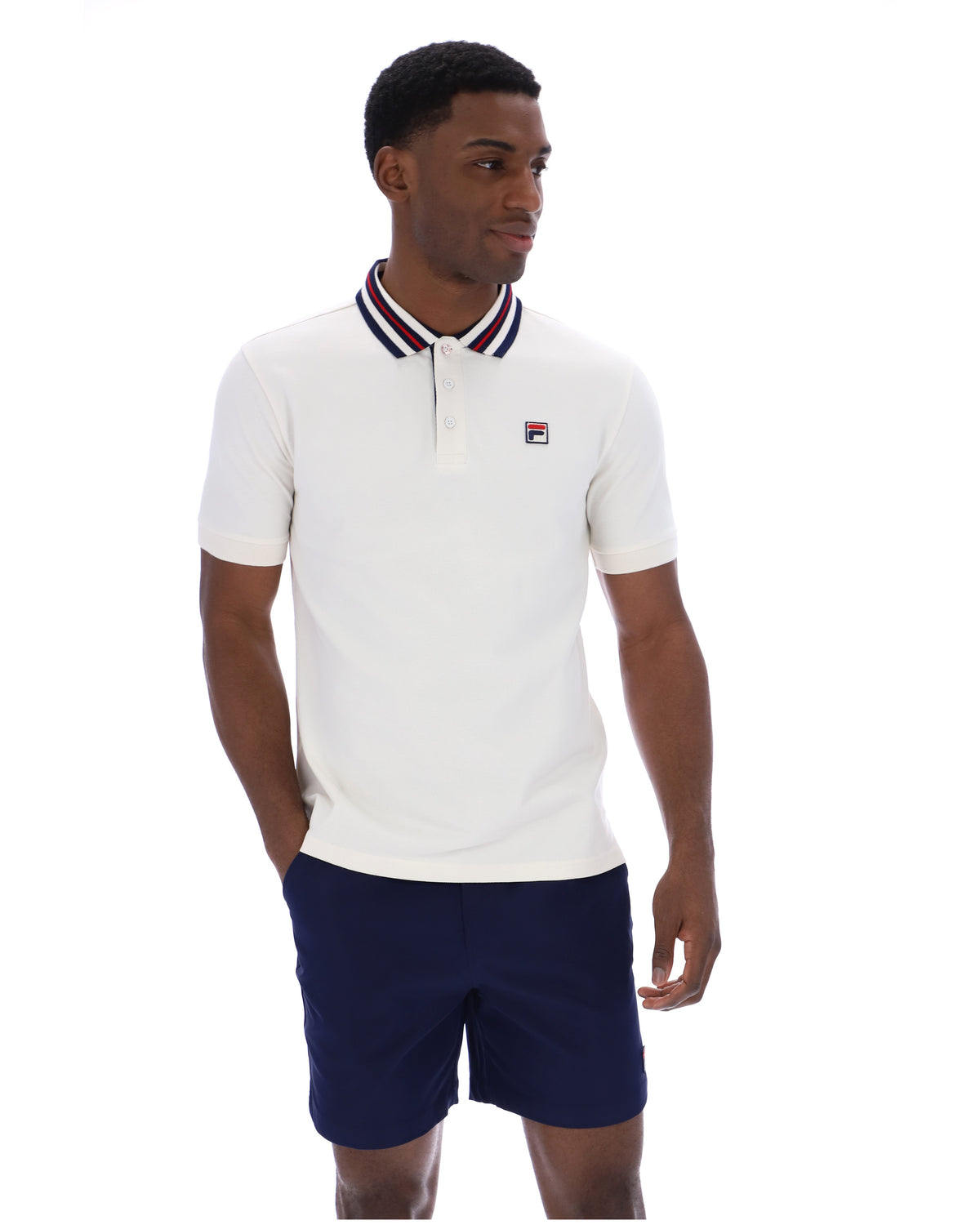 Displays a model wearing the Gardenia 'FILA' branded Achille Heritage Tape Basic Polo