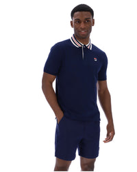 Man wearing a navy blue polo shirt and shorts set on a white background