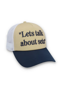 Displays the Classic Beige 'FILA' branded Addie Slogan Neoprene Mesh-Back Cap