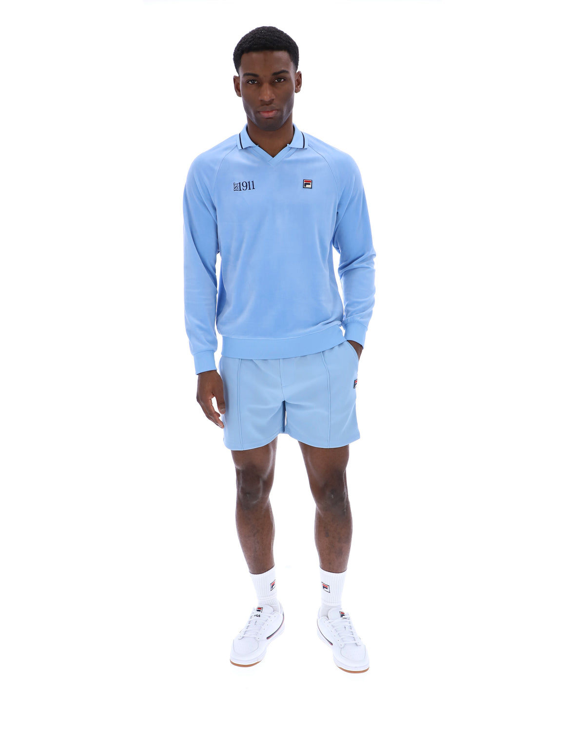 Displays a model wearing the Frozen 'FILA' branded Fjord Alfredo 1911 Velour Raglan Long-Sleeve Top