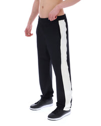 Black track pants with a white stripe on a white background