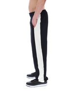 Black and white striped pants worn by a person on a white background