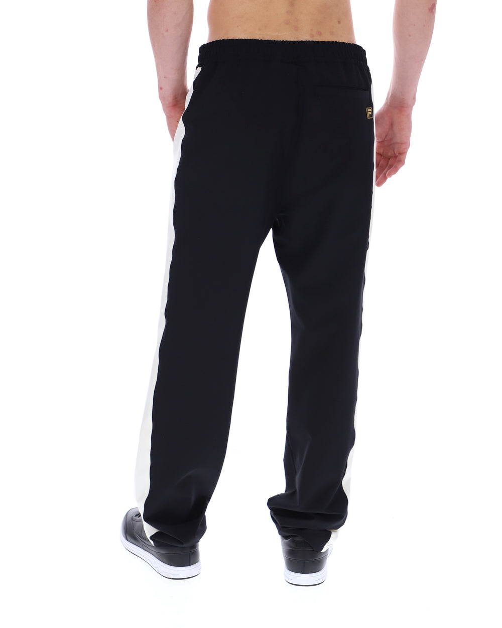 Black sweatpants with a white stripe on a white background
