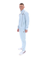 Man wearing a light blue tracksuit with a brand logo on a white background