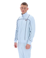 Man wearing a light blue tracksuit with a brand logo on a white background