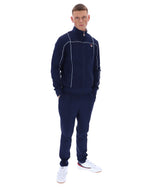 Man wearing a navy tracksuit with a brand logo on a white background