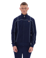 Man wearing a navy tracksuit with white piping on a white background