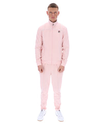 Man wearing a pink tracksuit on a white background