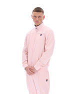 Person wearing a pink tracksuit with a brand logo on a white background