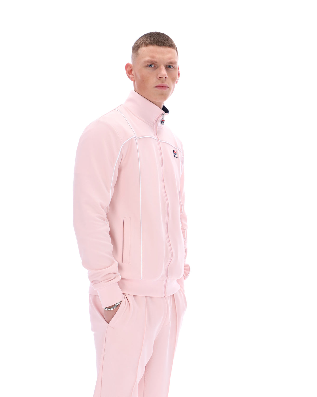 Man wearing a pink tracksuit on a white background