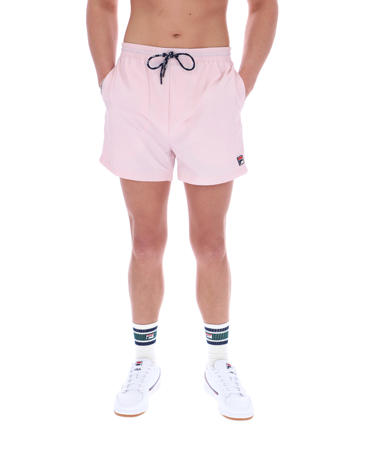 Person wearing pink shorts with a brand logo on a white background
