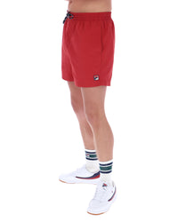 Red shorts worn by a person on a white background