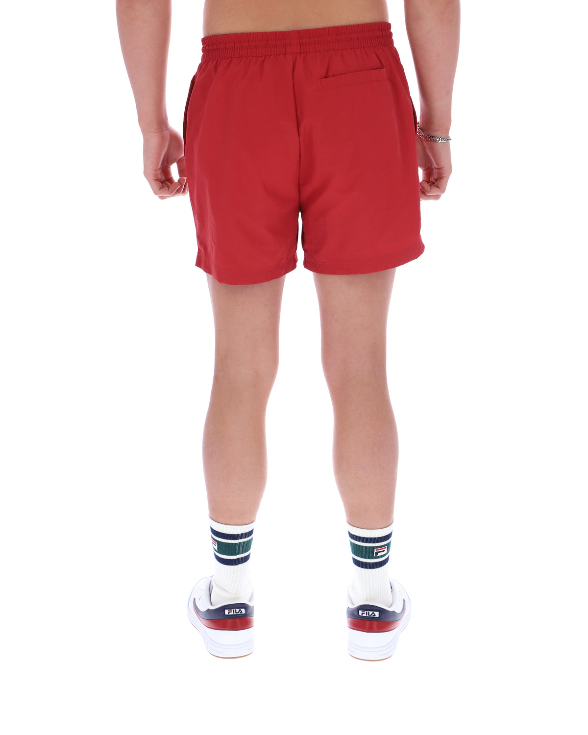 Red shorts worn by a person on a white background