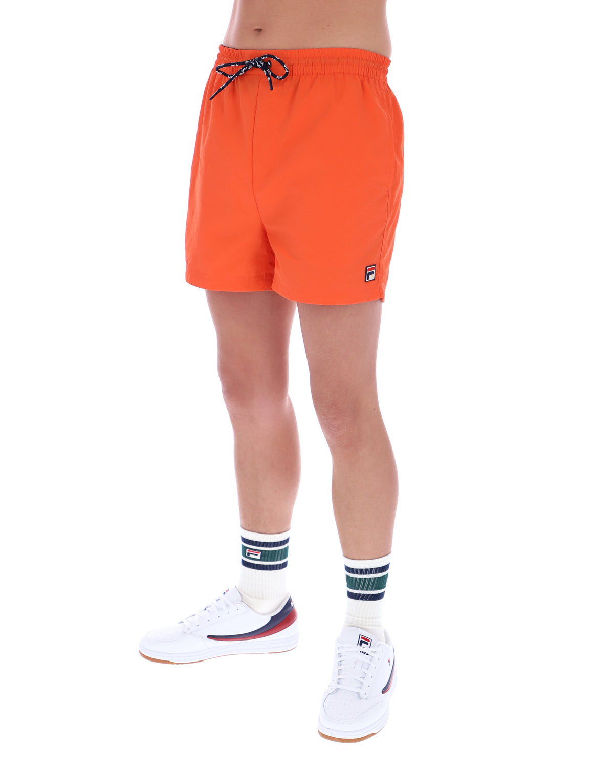 Orange swim shorts worn by a person on a white background