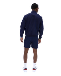 Displays a model wearing the Navy 'Fila' branded Arturo Coach Jacket