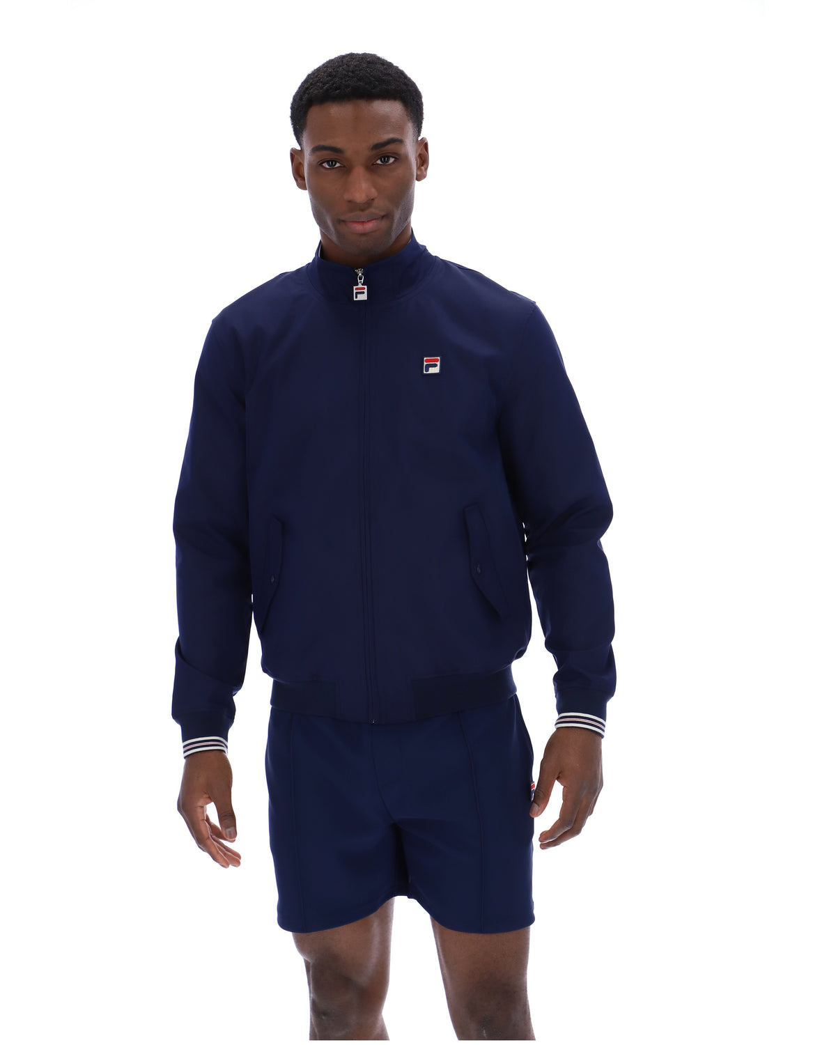 Displays a model wearing the Navy 'Fila' branded Arturo Coach Jacket