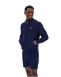 Displays a model wearing the Navy 'Fila' branded Arturo Coach Jacket