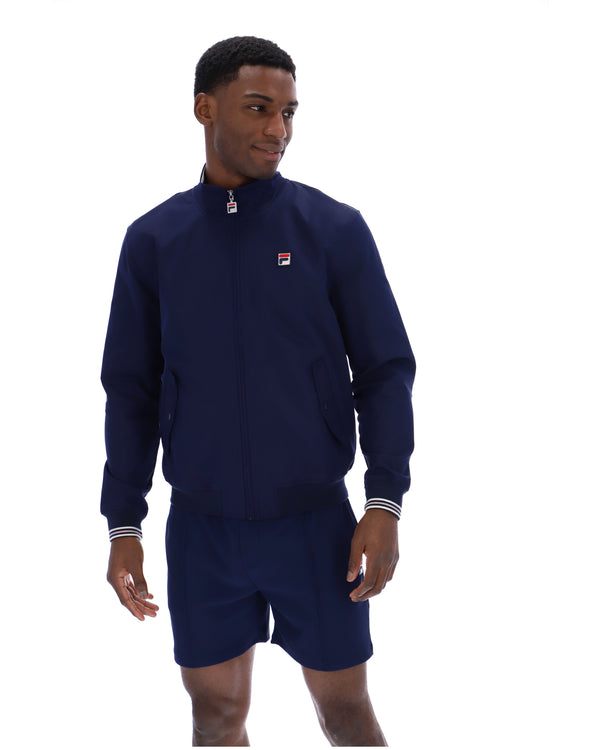 Displays a model wearing the Navy 'Fila' branded Arturo Coach Jacket
