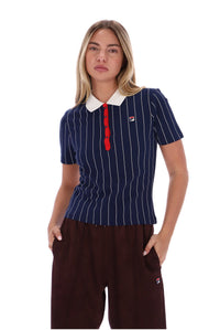 A woman modeling a short-sleeve polo shirt with navy blue and white vertical pinstripes, a white collar, and a red three-button placket. She is also wearing dark brown pants, photographed against a solid white background.