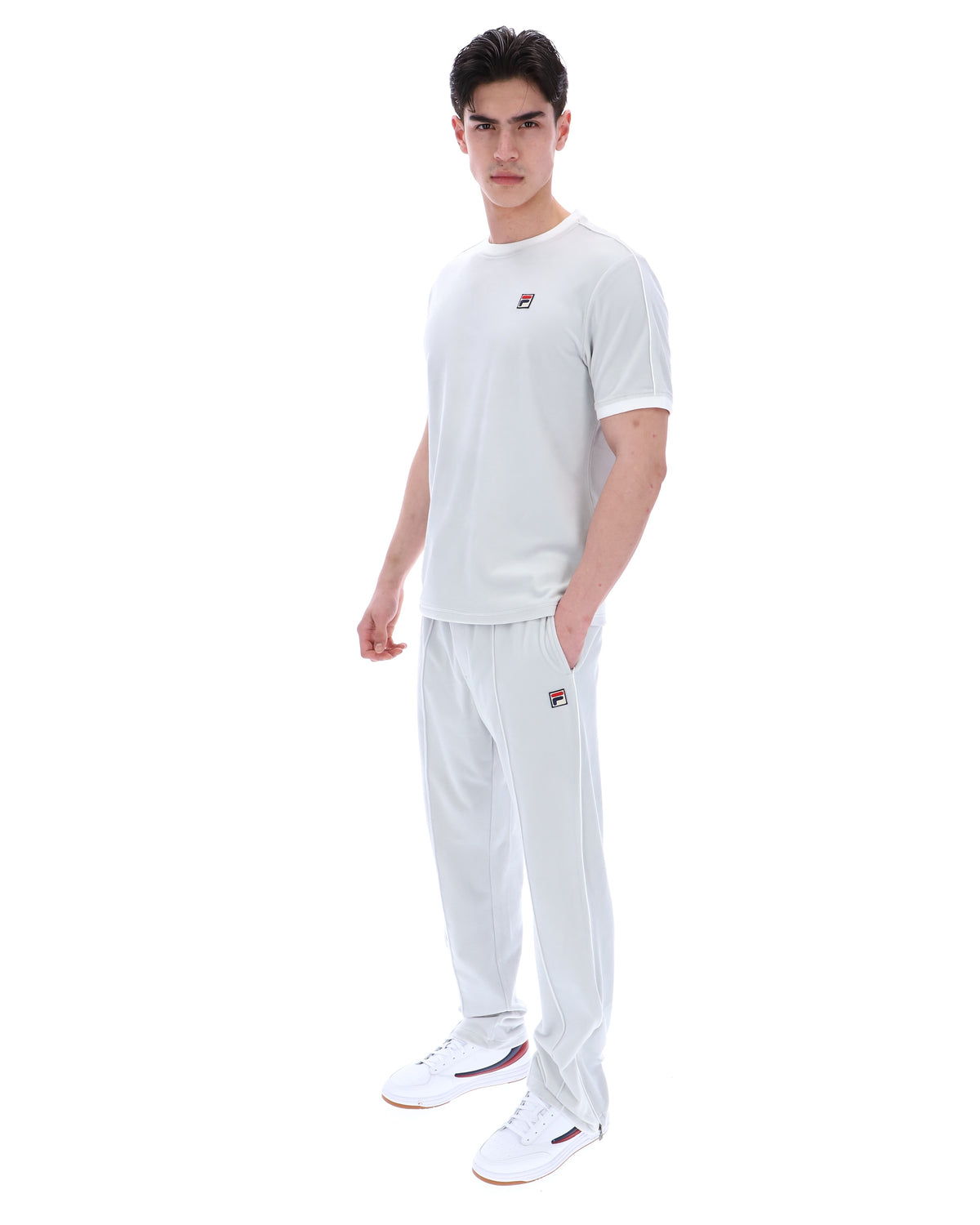 Man wearing a dawn blue t-shirt and pants with a logo on a white background