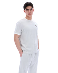 Man wearing a dawn blue t-shirt and pants on a white background