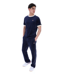 Person wearing a navy tracksuit with a brand logo on a white background