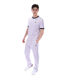 Person wearing a lilac t-shirt with a FILA logo, paired with matching joggers, on a white background