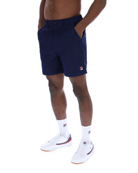 Displays a model wearing the Navy 'Fila' Caruso Chino Shorts