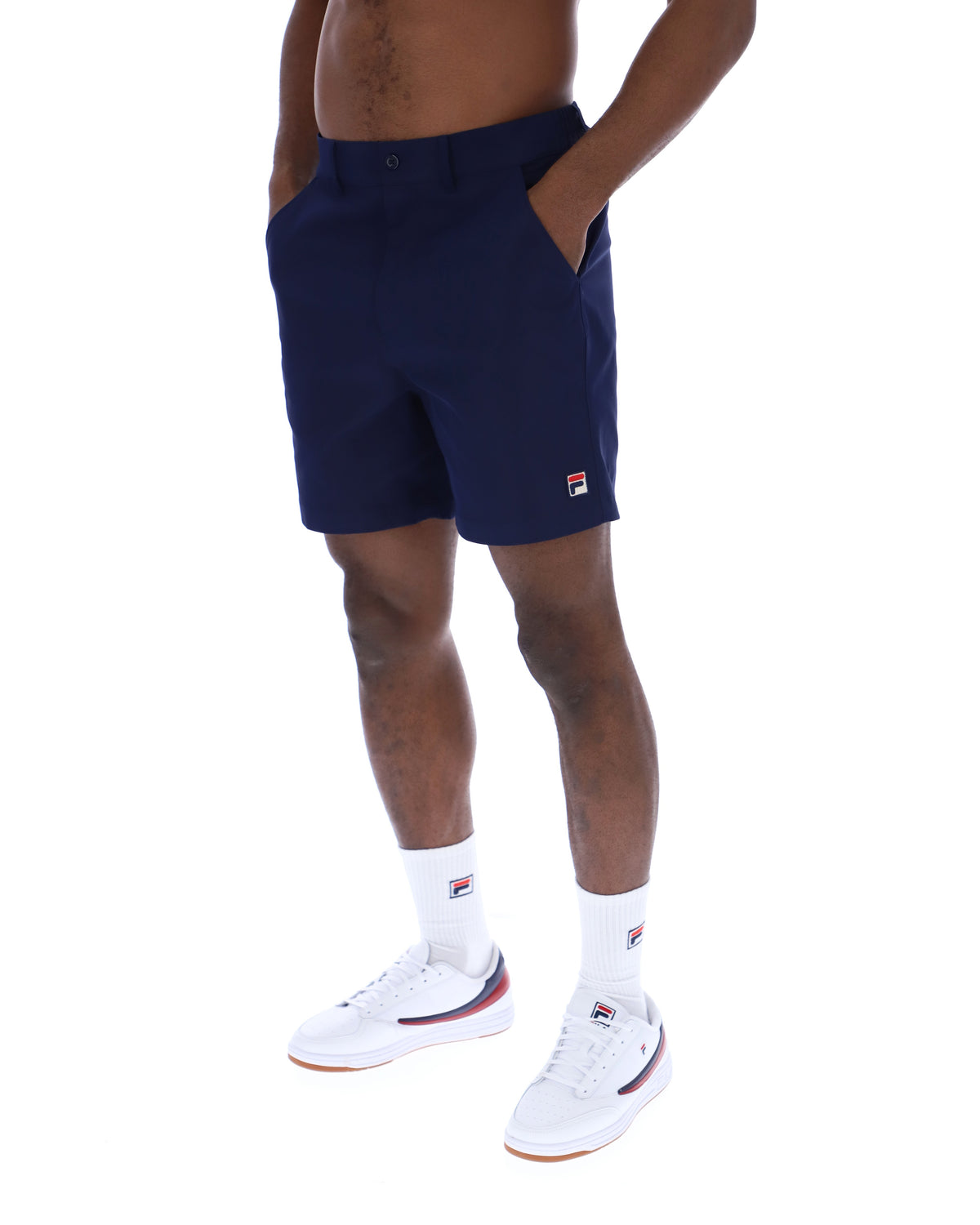 Displays a model wearing the Navy 'Fila' Caruso Chino Shorts