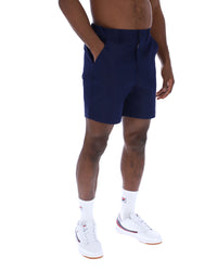 Displays a model wearing the Navy 'Fila' Caruso Chino Shorts