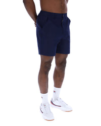 Displays a model wearing the Navy 'Fila' Caruso Chino Shorts