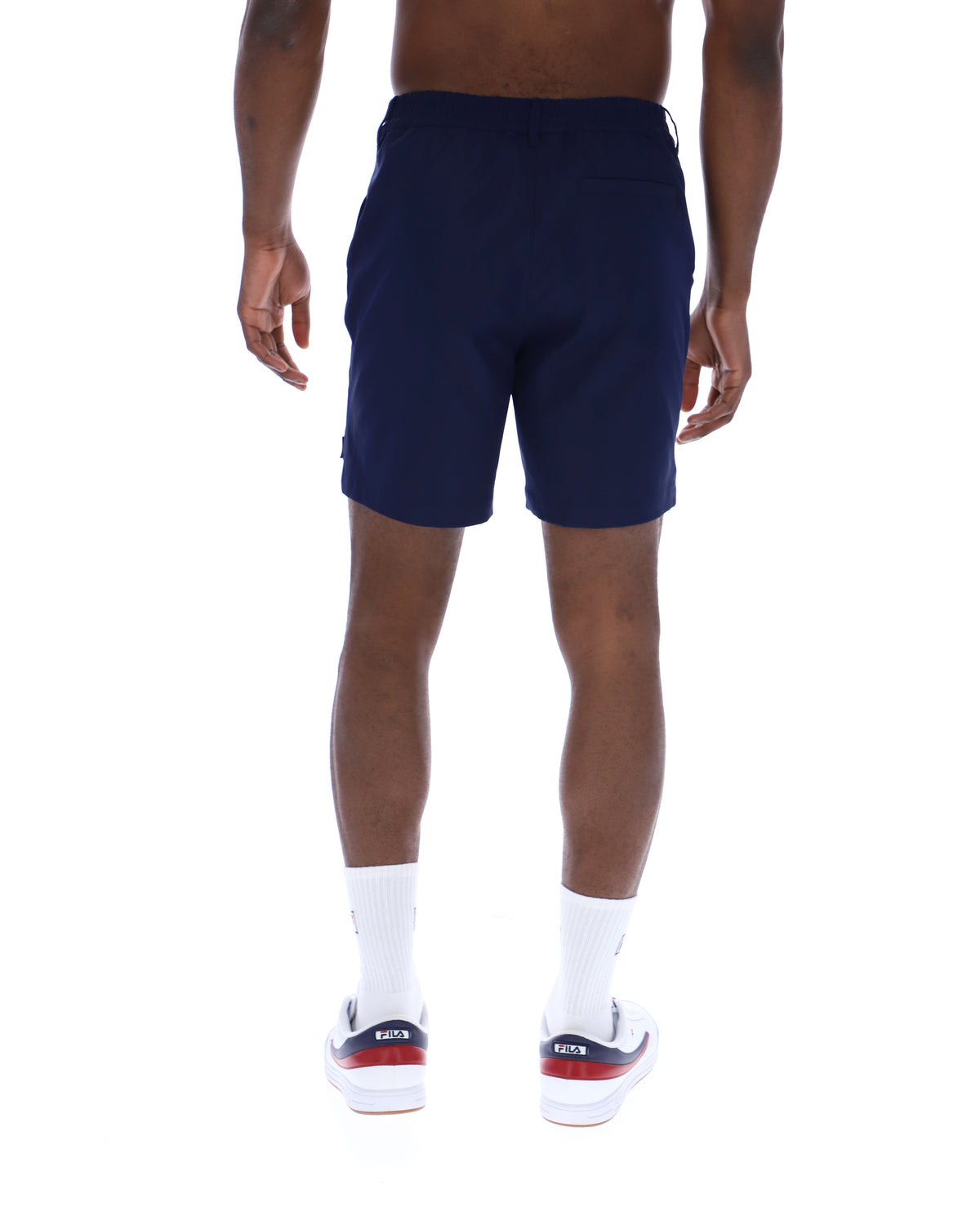 Displays a model wearing the Navy 'Fila' Caruso Chino Shorts