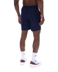 Displays a model wearing the Navy 'Fila' Caruso Chino Shorts