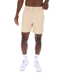 Displays the Classic Beige 'FILA' branded Caruso Chino Shorts