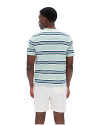 Man wearing a light blue and white striped polo shirt on a white background